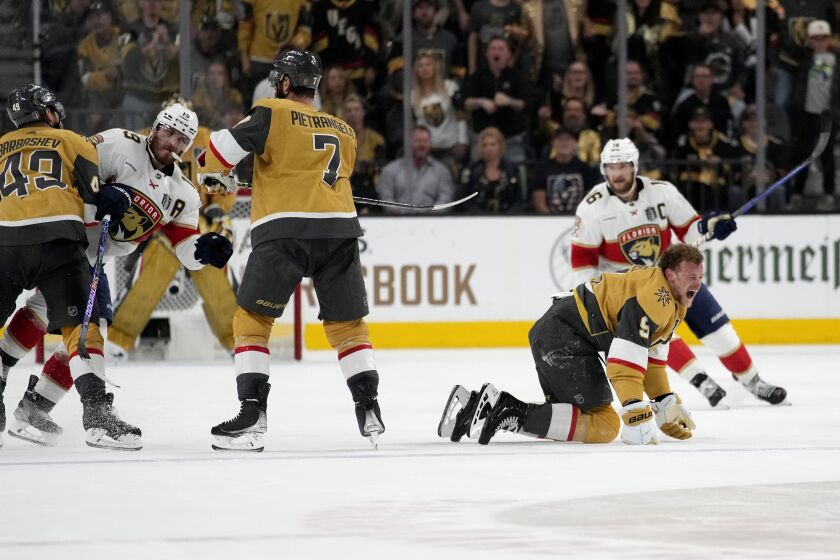 Vegas Golden Knights center Jack Eichel (9) yells after being hit by Florida Panthers left wing Matthew Tkachuk, left, during the second period of Game 2 of the NHL hockey Stanley Cup Finals, Monday, June 5, 2023, in Las Vegas. (AP Photo/John Locher)