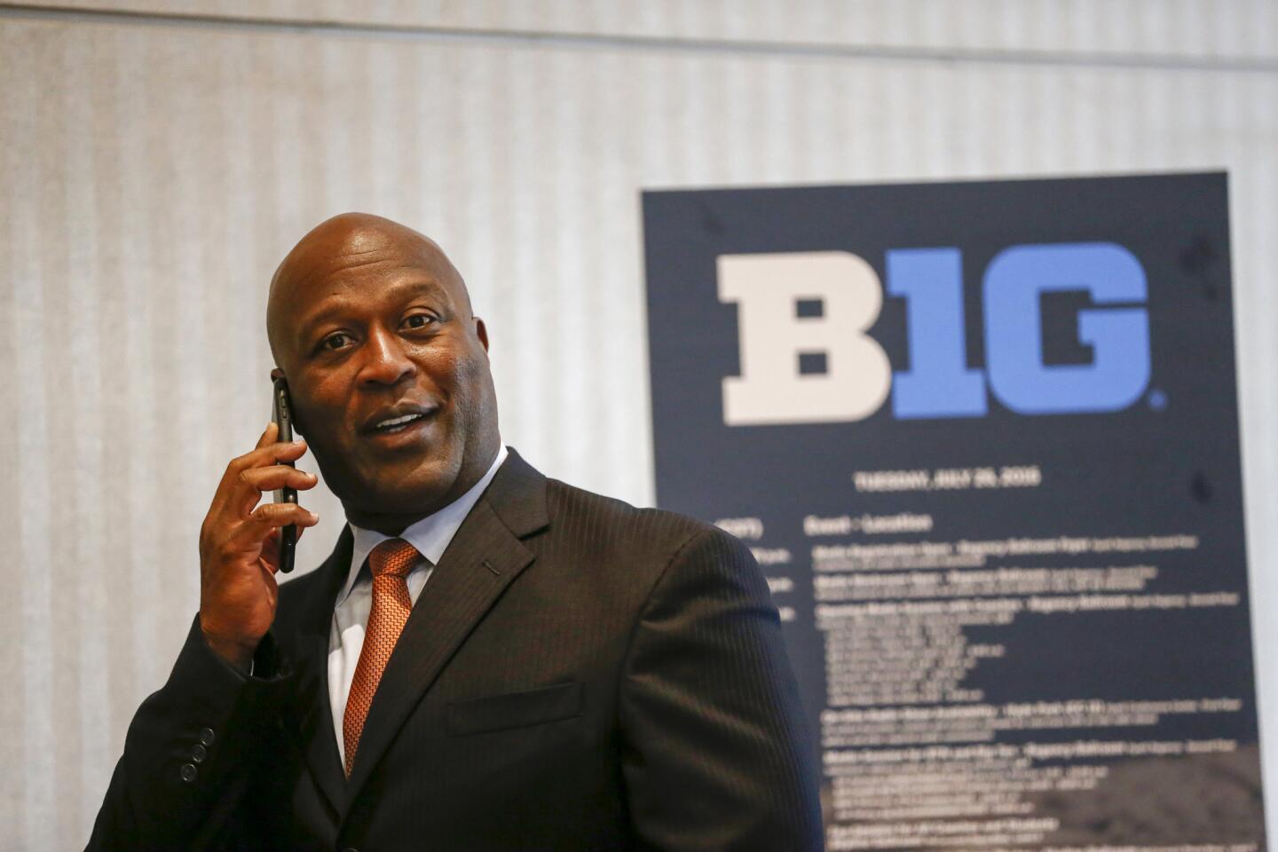 Illinois head coach Lovie Smith chats on the phone prior to taking the stage at the Big Ten football media day held at the Hyatt Regency McCormick Place on July 26, 2016.