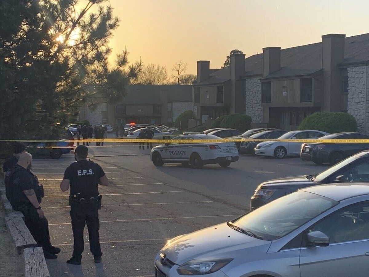 Police officers gather at the Crossings at Minshall Park apartment complex after two people were shot - one by an officer - Monday, April 11, 2022. (Jacob Factor/Tulsa World via AP)
