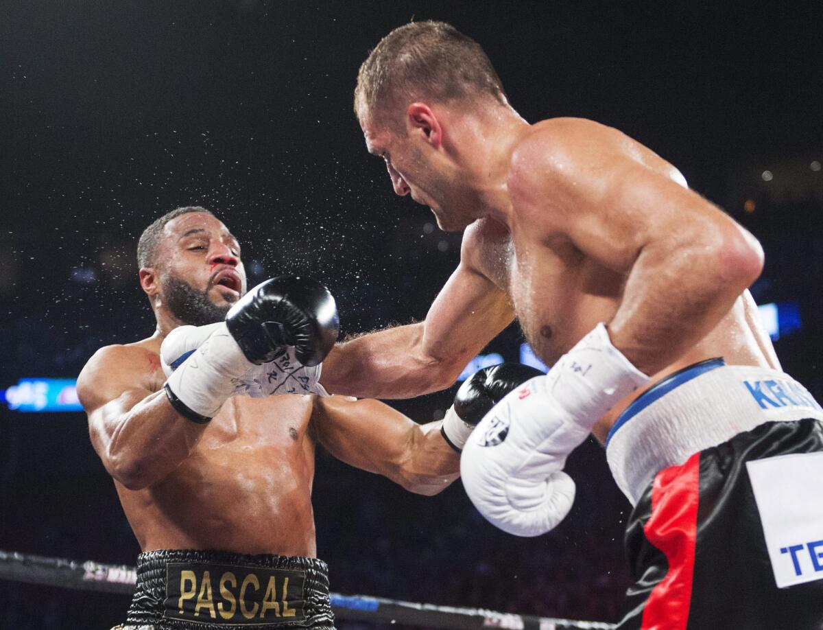 Sergey Kovalev, right, of Russia lands a right to the head of Canada's Jean Pascal during their light-heavyweight title fight on Jan. 30.