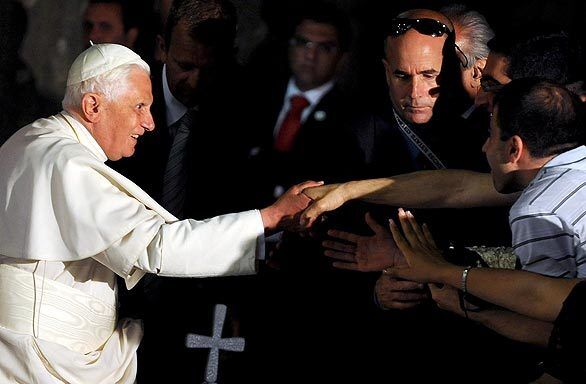 Pope Benedict XVI shakes hands with the faithful as he leaves the Grotto of Annunciation in the Galilee city of Nazareth.