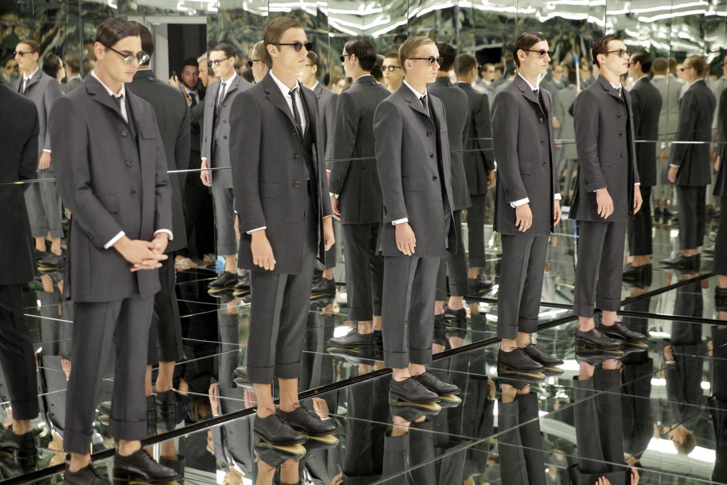 Models display fashions from Thom Browne.