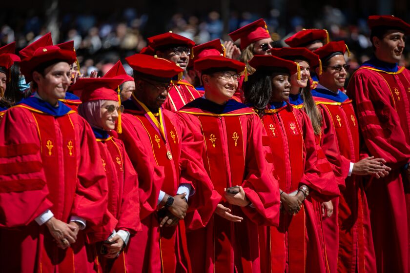 LOS ANGELES, CA - MAY 13: Graduates stand up and cheer as their school is announced at The University of Southern California's 2022 commencement ceremony on Friday, May 13, 2022 in Los Angeles, CA. (Jason Armond / Los Angeles Times)
