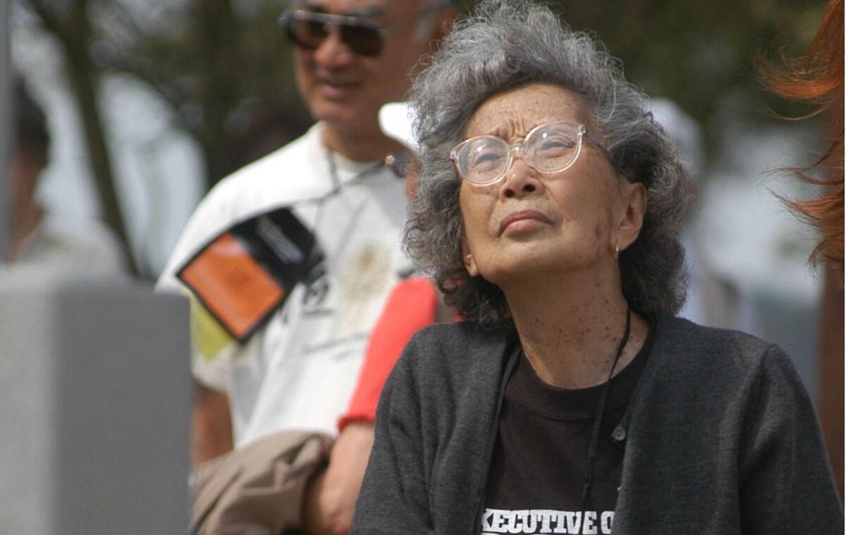 Yuri Kochiyama views a memorial erected for the inhabitants of a Japanese-American World War II internment camp, in Rohwer, Ark., on Sept. 26, 2004.