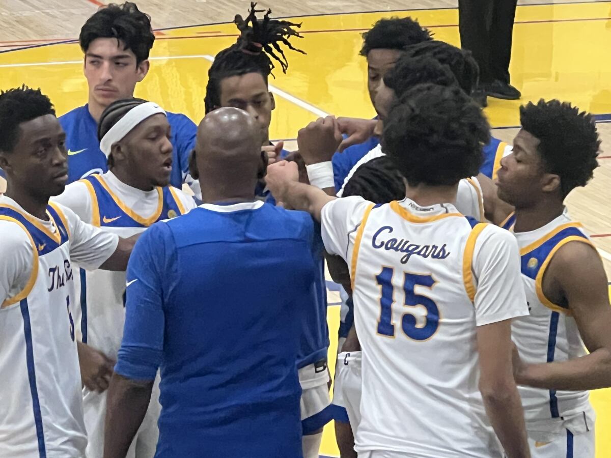 Crenshaw coach Ed Waters gathers his team during a timeout.