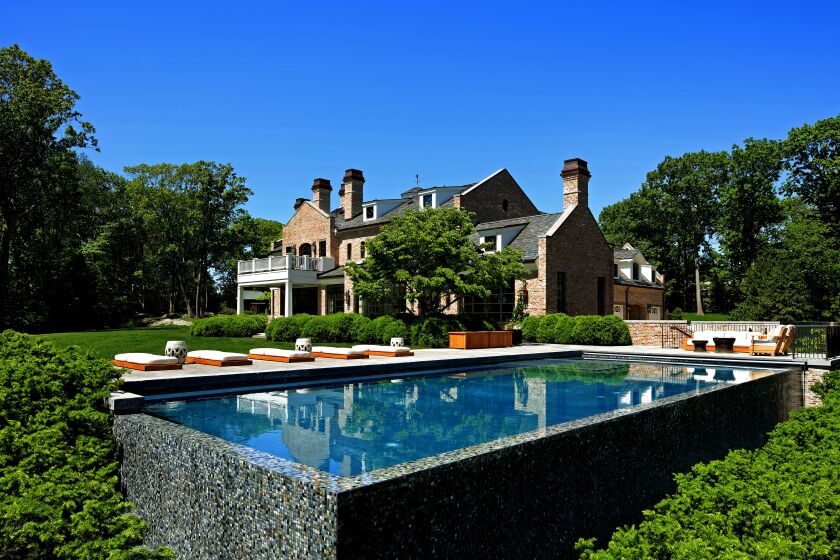 Tom Brady and wife Gisele Bündchen are now asking $33.9 million for their Massachusetts home, down about $6 million from when the five-acre estate first listed for sale last year. The Richard Landry-designed manor features a classic brick exterior, modern amenities and a country-inspired kitchen. The skylight-topped breakfast room features a wall of steel-framed doors and windows that takes in leafy views. A barn-inspired guest house accompanies the 10,000-square-foot main house. Elsewhere on the grounds is a zero-edge swimming pool.
