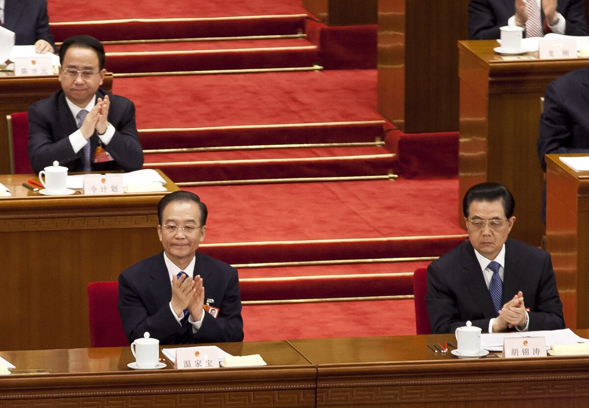 Ling Jihua, top left, an aide and confidant to then-President Hu Jintao, bottom right, attends a plenary session of the National People's Congress at the Great Hall of the People in Beijing on March 11, 2012.