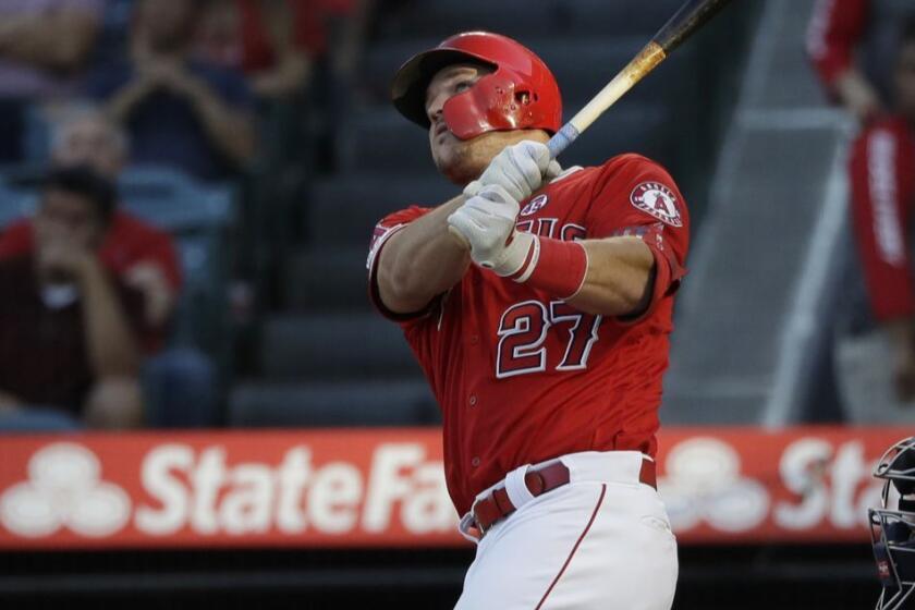 Los Angeles Angels' Mike Trout follows through on a two-run home run against the Seattle Mariners during the third inning of a baseball game Saturday, July 13, 2019, in Anaheim, Calif. (AP Photo/Marcio Jose Sanchez)