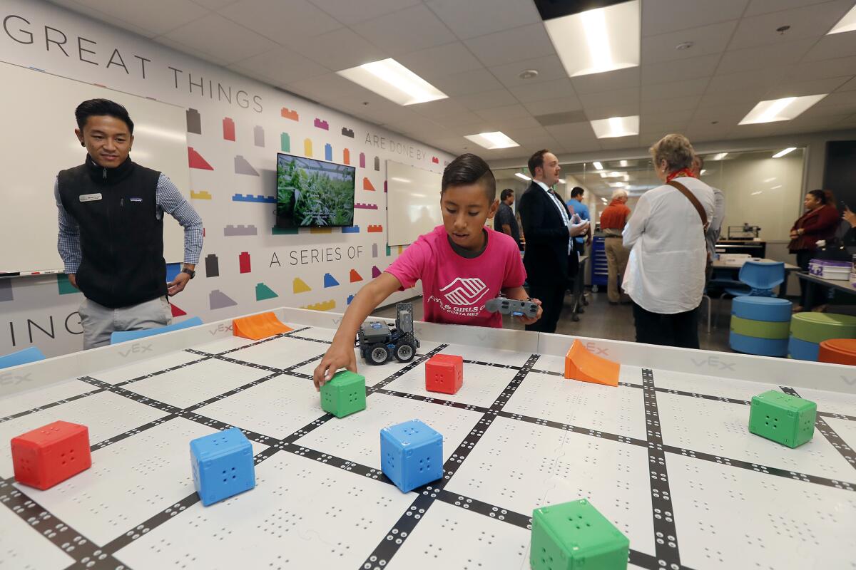 Elguer Medina, 12, sets up blocks as he plays with a Vex 10, which children can use to study robotics and coding in the Maker Space at the newly renovated Boys & Girls Club of Costa Mesa on Tuesday.