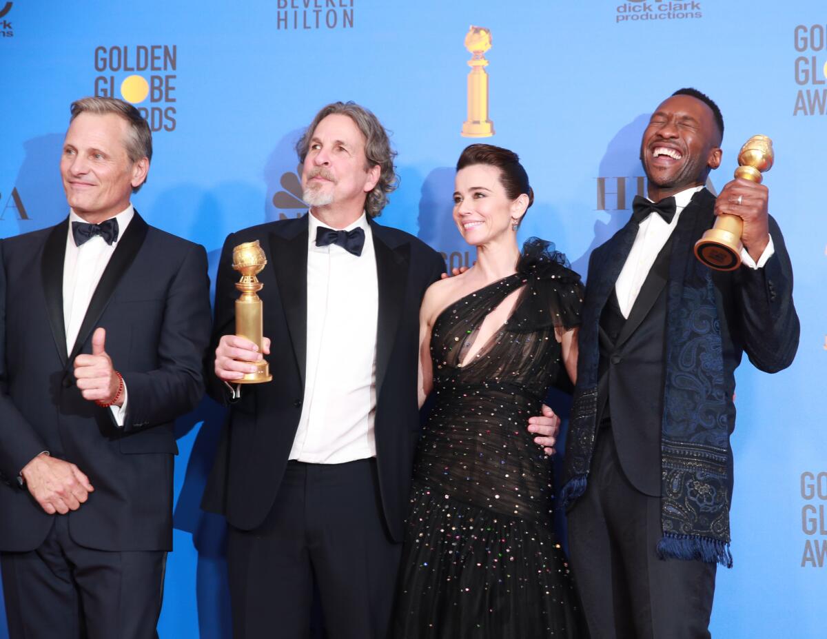 From left, "Green Book's" Viggo Mortensen, director Peter Farrelly, Linda Cardellini and Mahershala Ali gather backstage.