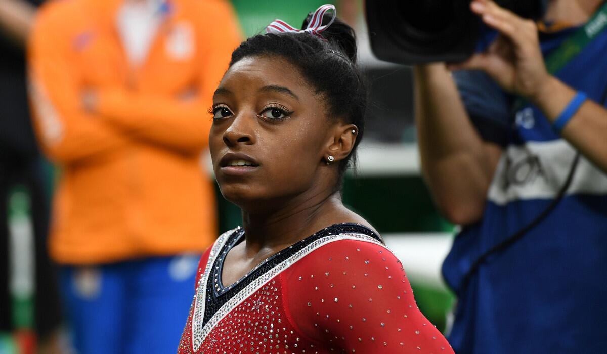 U.S. gymnast Simone Biles finishes third in the women's balance beam at the Rio Olympics after a significant deduction for a mistake.