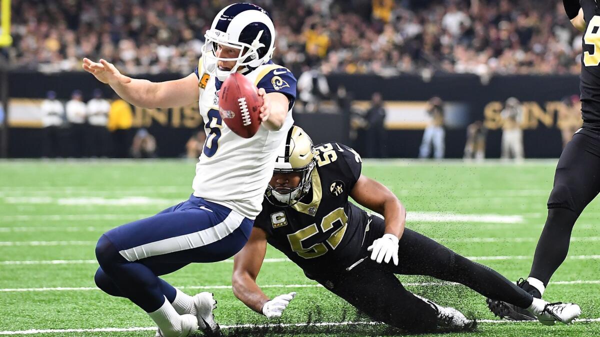 Rams holder Johnny Hekker can't make the first down on a fourth-down run as linebacker Craig Robertson makes the tackle in the first quarter at the Mercedes-Benz Superdome on Nov. 4, 2018.