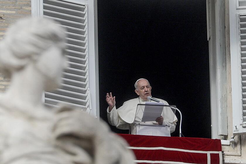 Pope Francis recites a prayer from his studio window overlooking St. Peter's Square on Sunday.
