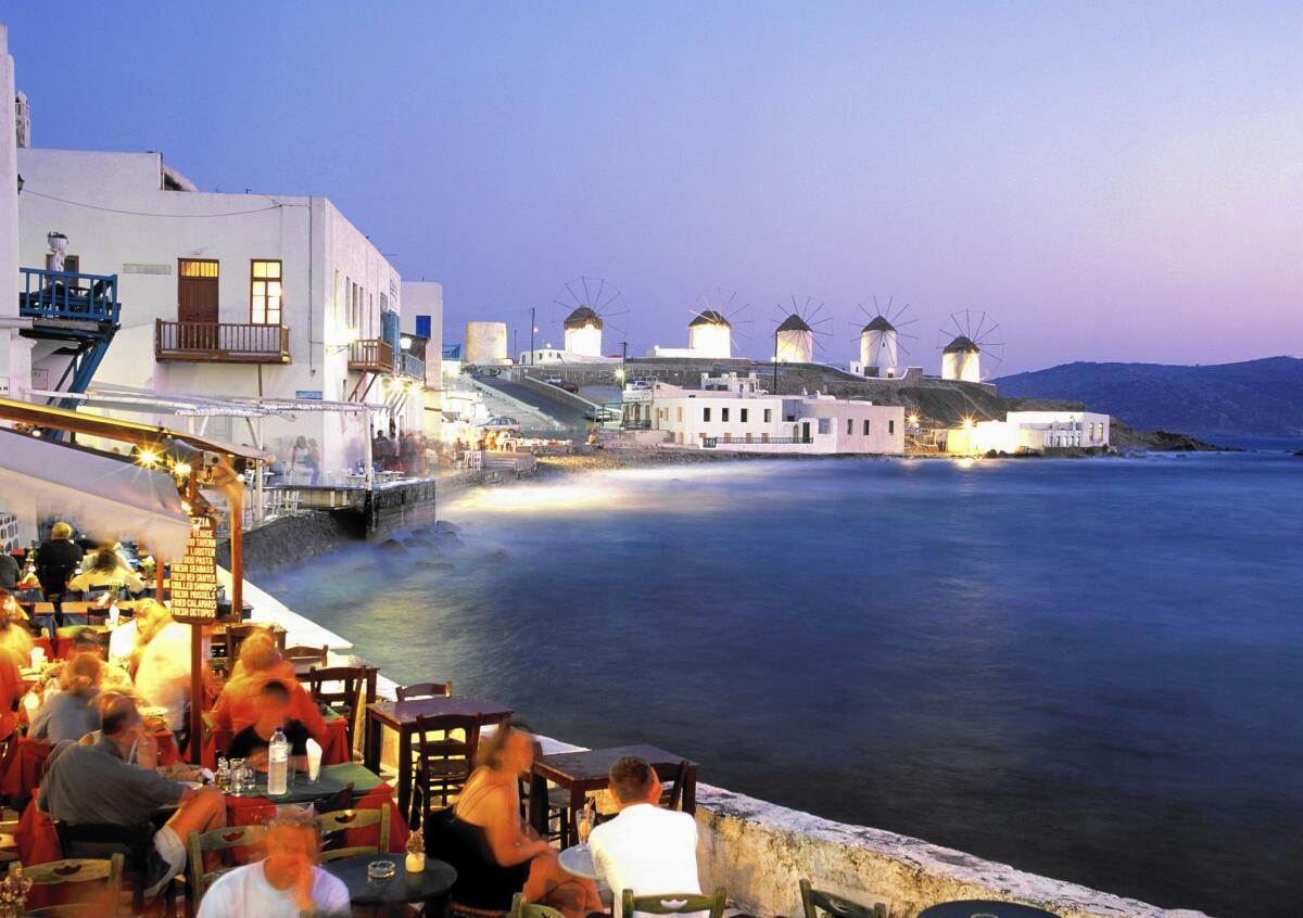 Alfresco dining in the town of Mykonos, Greece, offers stunning sea views.
