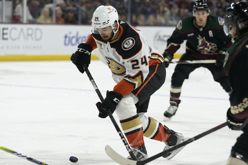 Anaheim Ducks' Bo Groulx (24) controls the puck in front of Arizona Coyotes' Clayton Keller.