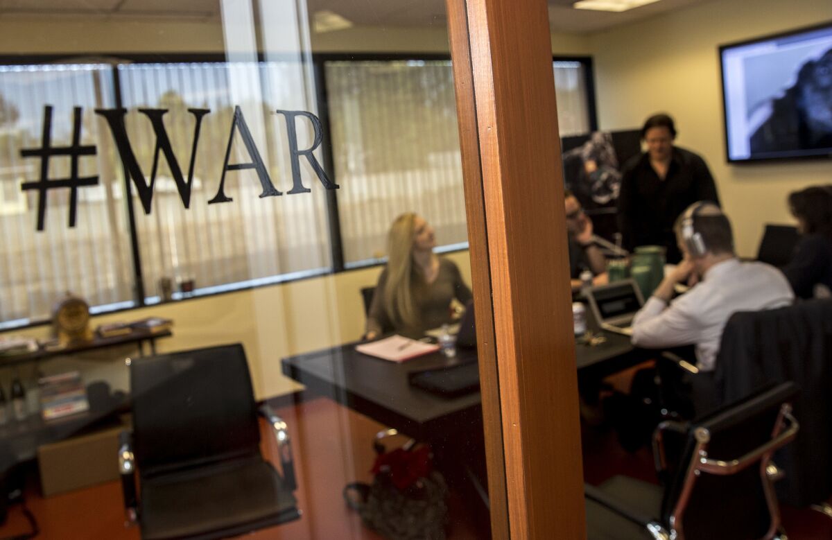 Breitbart News staff members congregate in the conference room of the company's L.A. office.