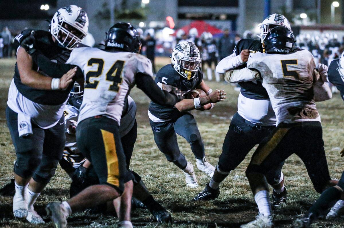 Damian Cornejo of Garfield runs through a hole created by his linemen against San Pedro.