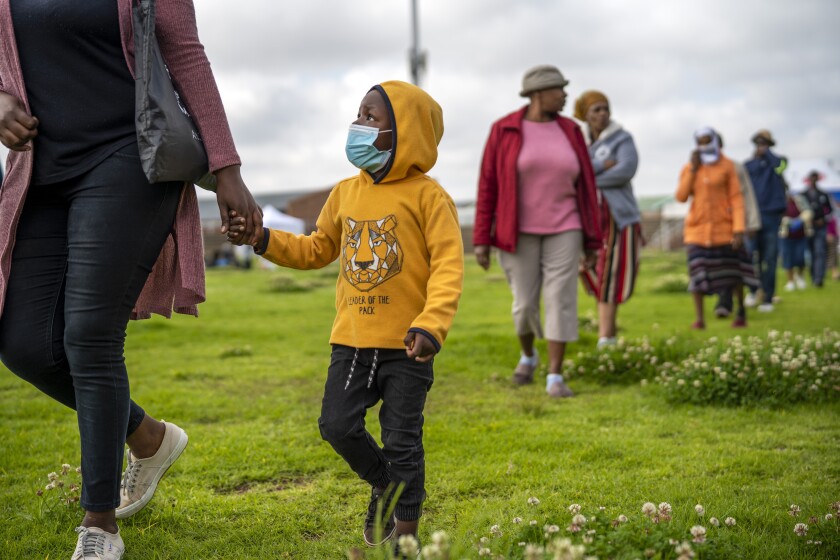 Residents from the Alexandra township in Johannesburg gather in a stadium to be tested for COVID-19 on Monday. South Africa will began a phased easing of its strict lockdown measures on May 1, although its confirmed cases of coronavirus continue to increase.