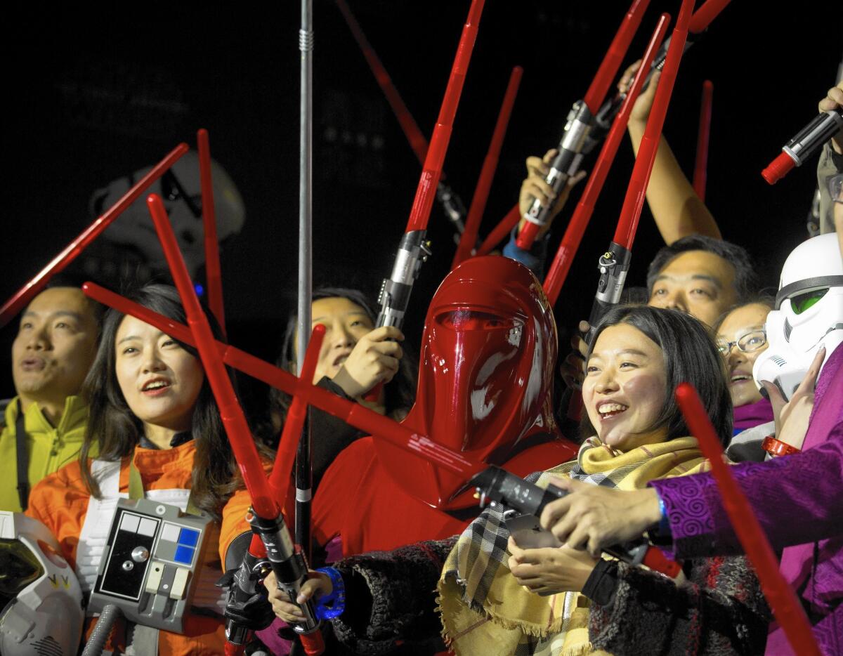 As "Star Wars" has a decades-long history of success, it's uncertain that other films could replicate its marketing strategy. Here, fans of the sci-fi saga gather in Beijing during an October event.