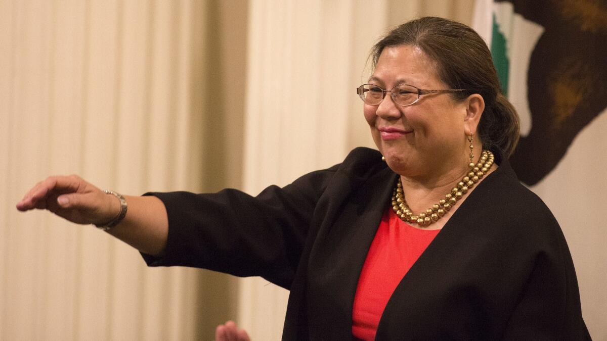 California State Controller Betty Yee waves after being acknowledged during a legislative session in 2016. In July, she was injured in an accident involving a driver suspected of being impaired by marijuana.