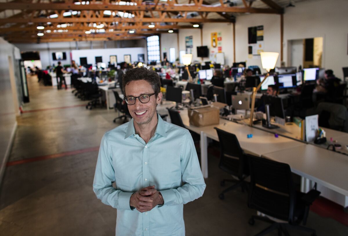 BuzzFeed CEO Jonah Peretti smiling inside a Buzzfeed office in 2019.