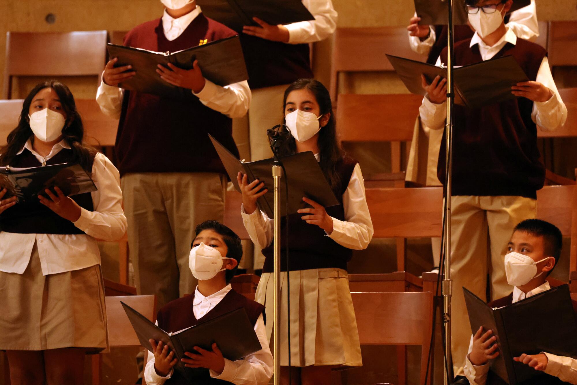 A group of children sing during Mass