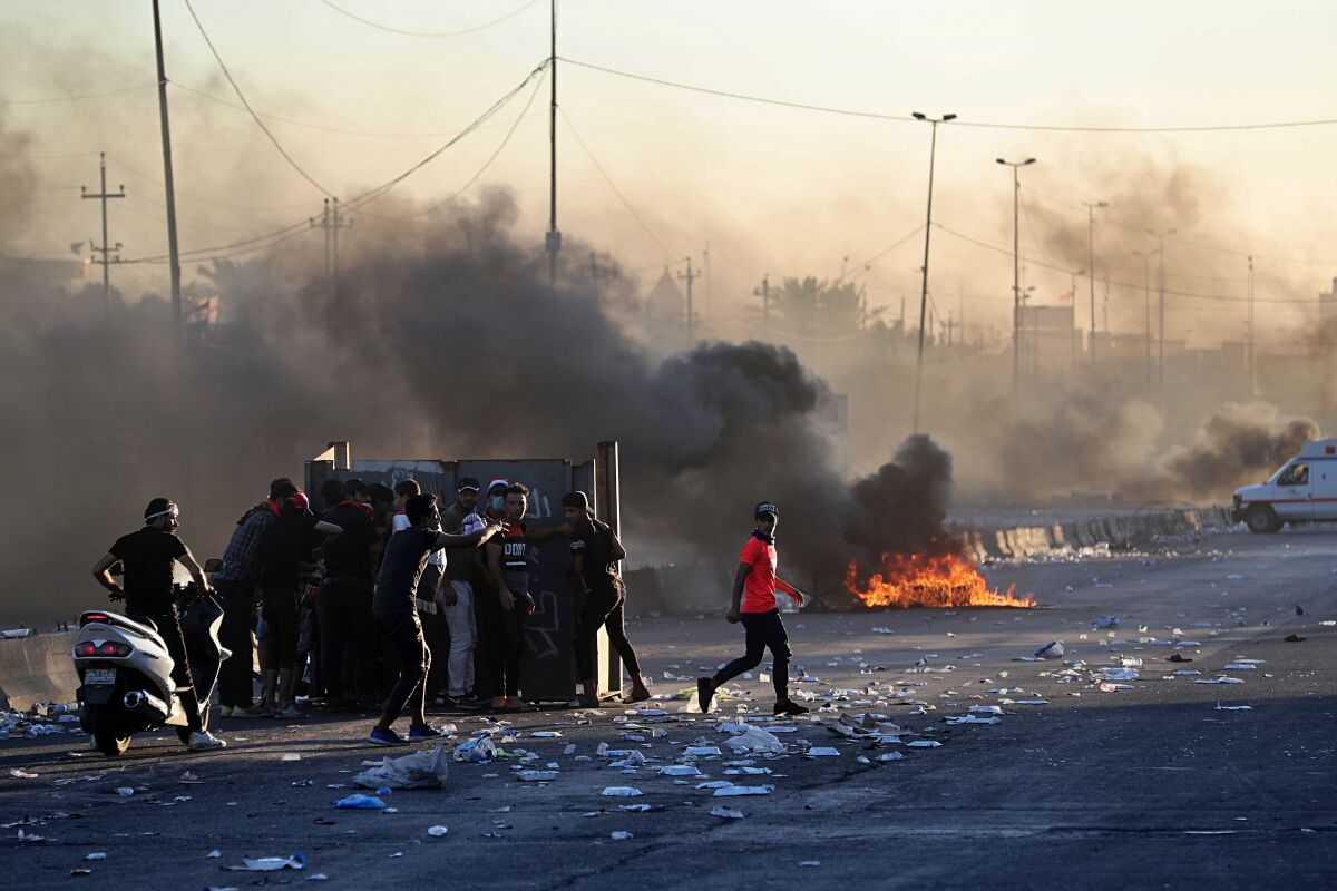 Anti-government protesters set fires, closing down a street, during a demonstration in Baghdad on Oct. 4.