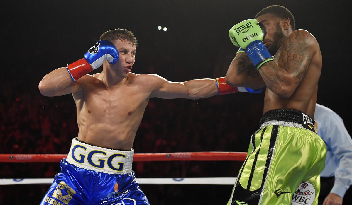 Gennady Golovkin, left, connects with Dominic Wade during a middleweight title boxing match on Saturday at The Forum.