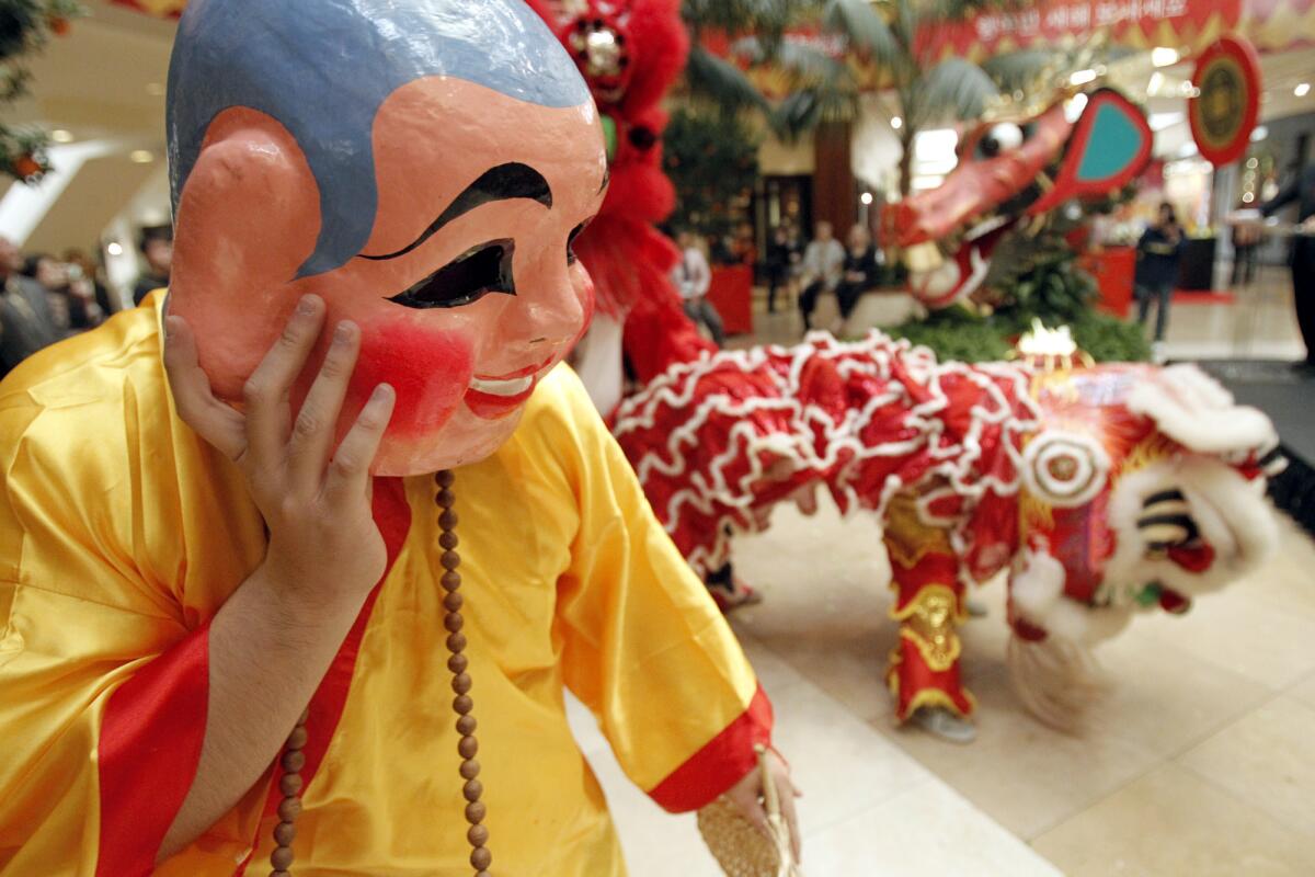 A performer dressed as a Buddhist monk during a dragon dance celebrating Chinese New Year at South Coast Plaza's Jewel Court in 2012.