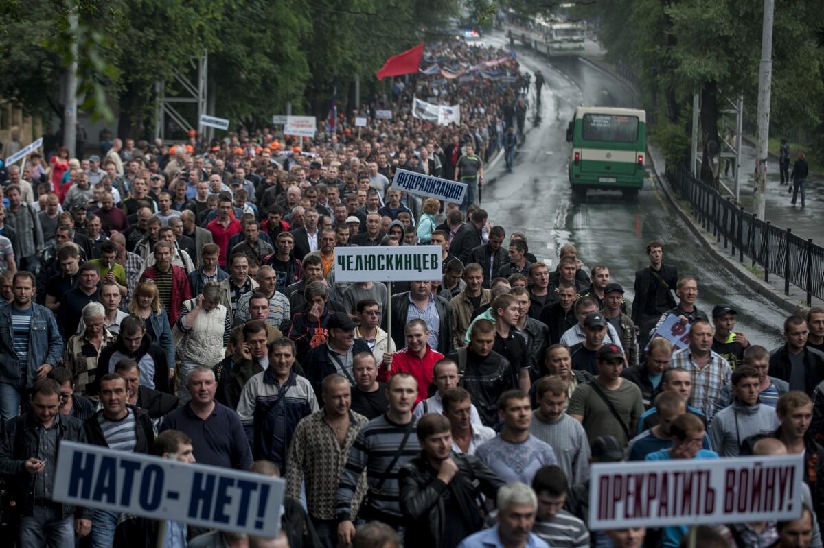 Hundreds of miners marched through the violence-wracked eastern Ukrainian city of Donetsk on Wednesday to demand a peaceful resolution of the conflict between pro-Russia separatists and the Ukrainian government.