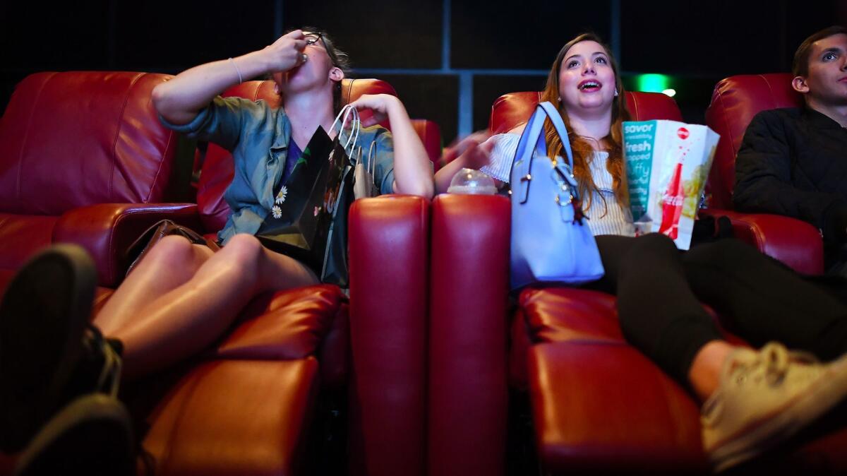 Morgan Gerlach, left, and Natalie Gold recline in living room-style theater seats at the AMC Santa Monica 7.