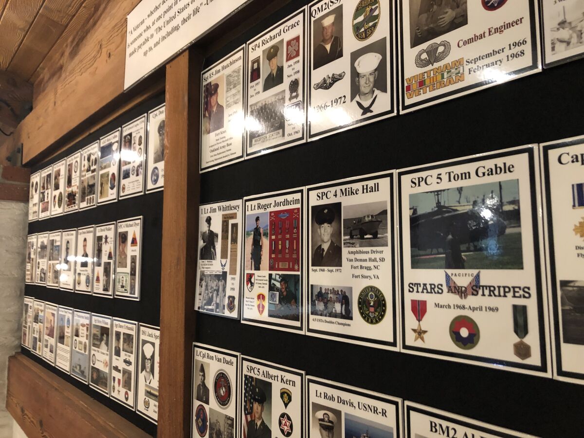 The country club honors its veteran members with a wall of placards.