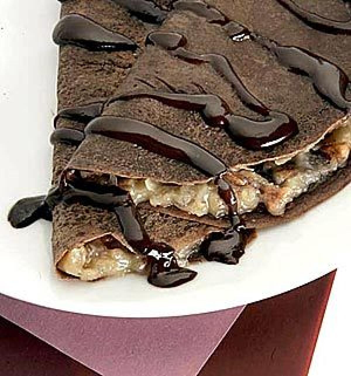 The crepes themselves are made with melted chocolate, enfold the custard filling, then topped with just a drizzle of melted chocolate and cream.