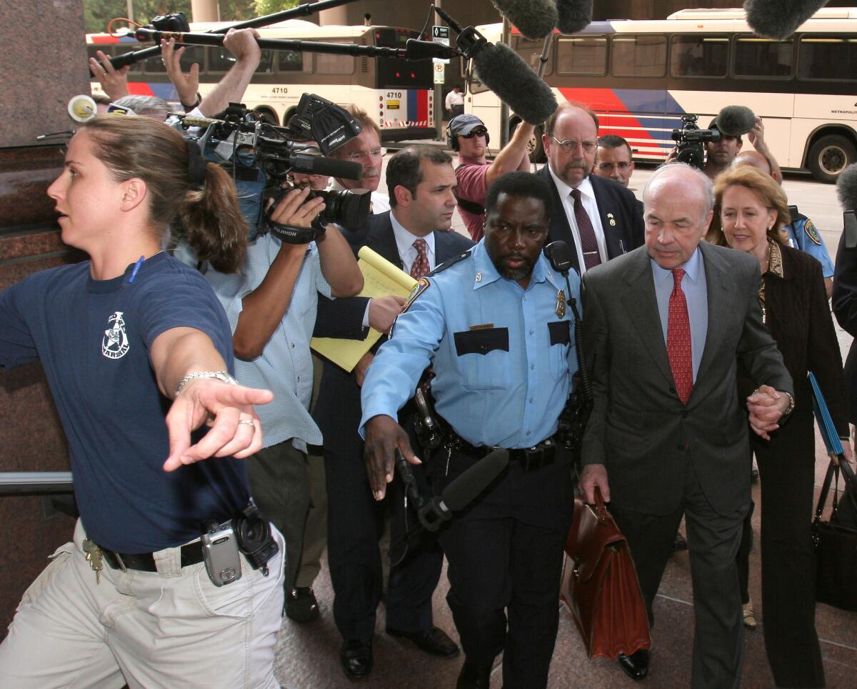 Enron founder Ken Lay (in red tie) being led from his fraud trial in 2006. Without short-sellers, the Enron ripoff might have continued for years.