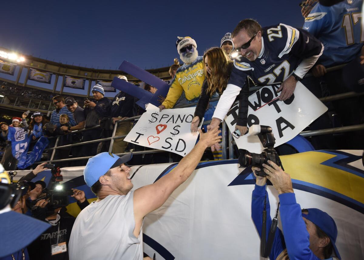 Quaterback Philip Rivers reaches out to Chargers fans after a victory over the Miami Dolphins at Qualcomm Stadium on Dec. 20.