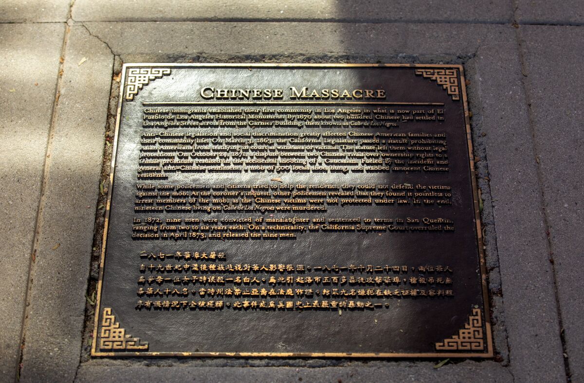 A view of the plaque embedded into the sidewalk that commemorates the Chinese Massacre of 1871