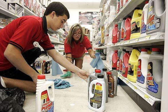 Marc Fernandez and Carrie Medina clean up drain cleaner that fell from shelves at the ACE Hardware Store at 4200 Chino Hills Parkway in Chino Hills during the earthquake this morning.