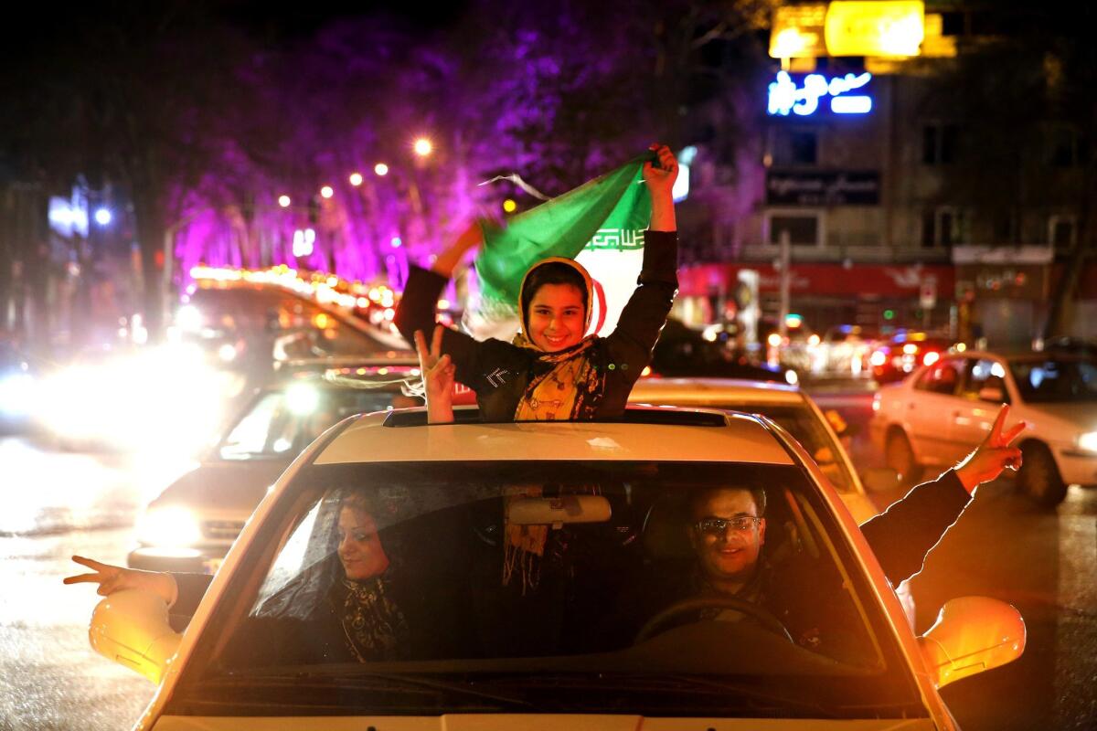 Iranians celebrate on a street in northern Tehran on Thursday after the announcement of a nuclear agreement with world powers.