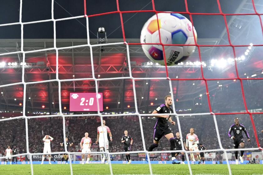 Bayern's Harry Kane scores from the penalty spot during the German Bundesliga soccer match between Leipzig and Bayern Munich, at the Red Bull Arena stadium in Leipzig, Germany, Saturday, Sept. 30, 2023. (Hendrik Schmidt/dpa via AP)