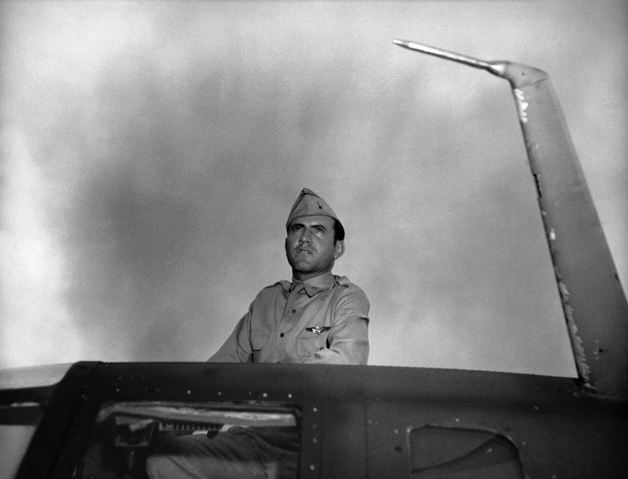 Louis Zamperini, a bombardier in the Army Air Force, peers out of the hatch nose of a bomber. Zamperini survived 47 days adrift on a raft in the Pacific Ocean before being captured by Japanese soldiers.