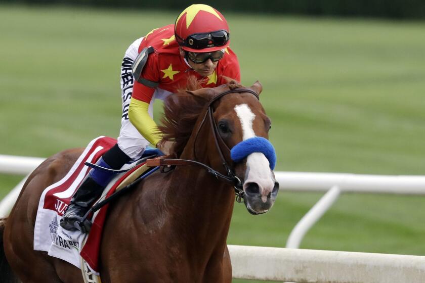 Jockey Mike Smith rides Justify into the far turn during the Belmont Stakes horse race, Saturday, June 9, 2018, at Belmont Park in Elmont, N.Y. Justify won the race, to claim horse racing's Triple Crown. (AP Photo/Mark Lennihan)