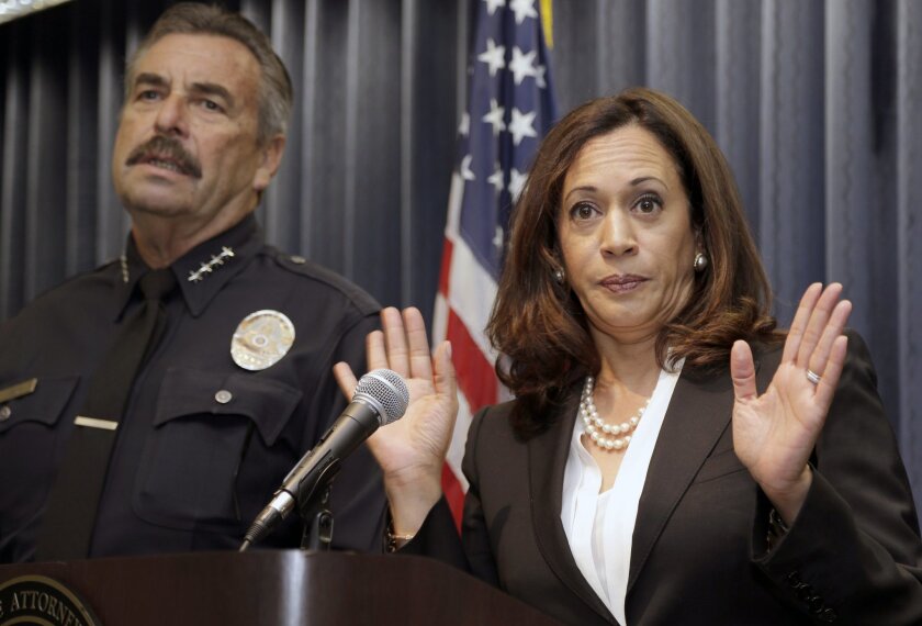 California Attorney General Kamala Harris, righ, joined by Los Angeles Police Chief Charlie Beck, speaks during a news conference to announce a criminal justice open database in Los Angeles, Wednesday, Sept. 2, 2015.