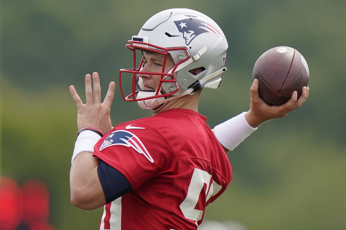 New England Patriots quarterback Mac Jones winds up for a pass during an NFL football practice, Wednesday, Aug. 4, 2021, in Foxborough, Mass. (AP Photo/Steven Senne)