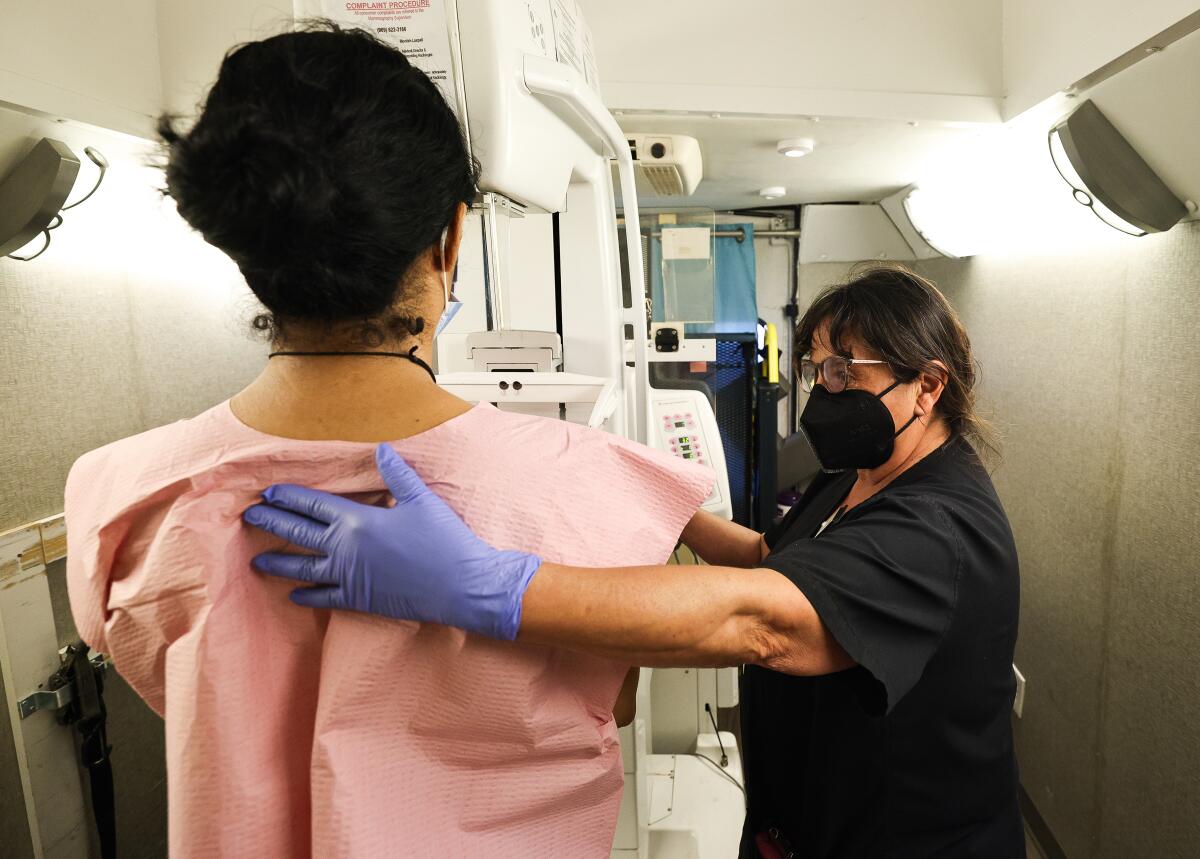 a woman receives a mammogram in a medical van