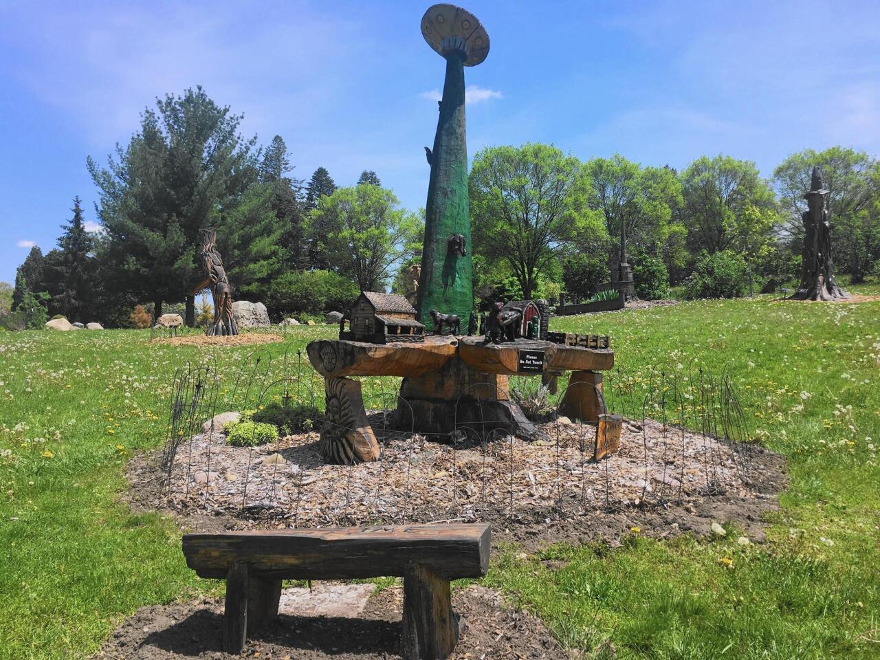 The Battle Creek Fantasy Forest at the Leila Arboretum is a park with sculptures carved from trees killed by the emerald ash borer. This one, by Mike Ayers, is titled “The Strange Disappearance of Old MacDonald.”