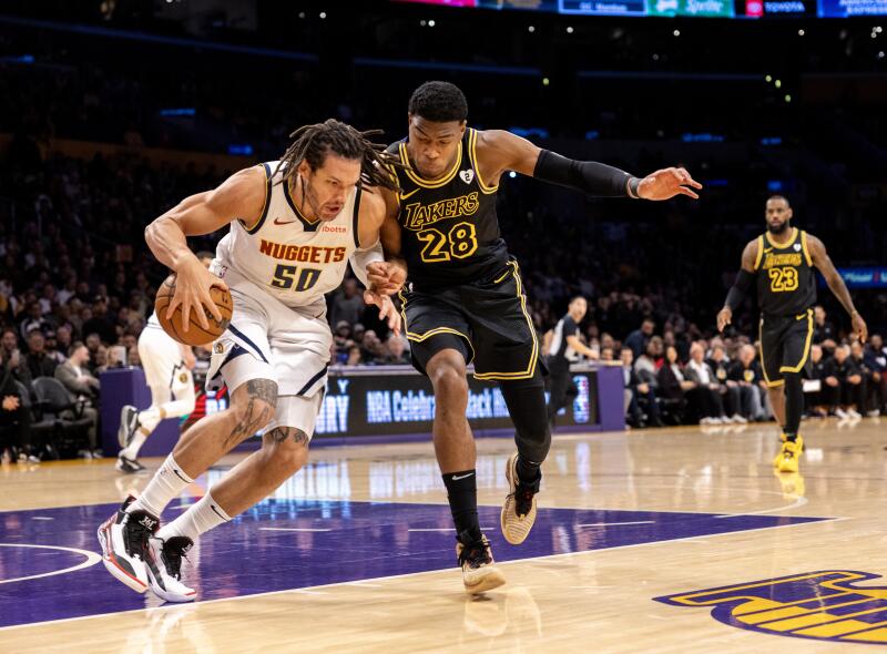 Lakers forward Rui Hachimura, right, plays tight defense on Denver forward Aaron Gordon.