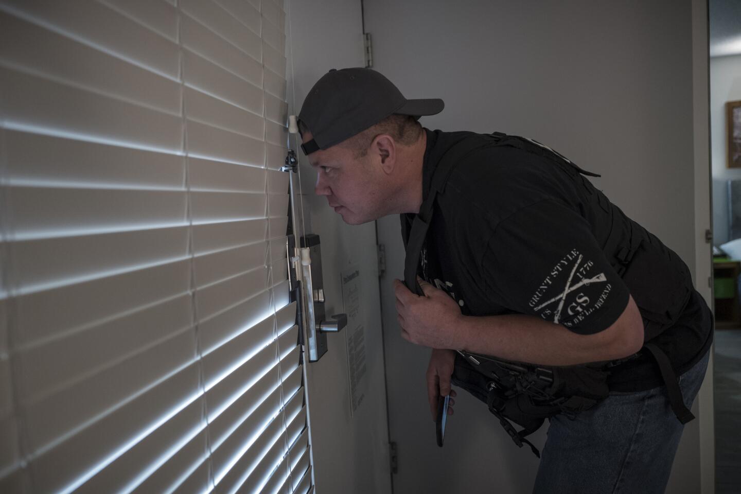 At a Santa Clara hotel for a sting operation targeting prostitution and human trafficking, California Parole Officer J. Routt waits for suspects to arrive.