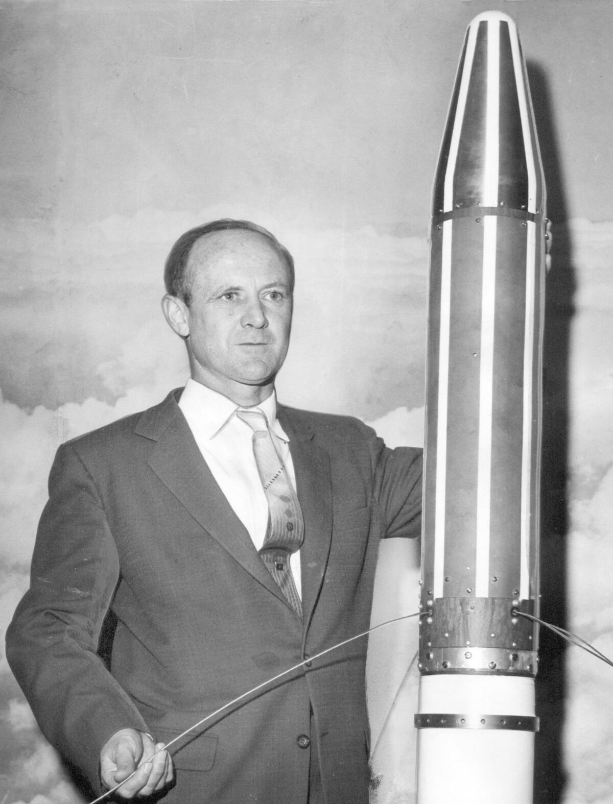 William Pickering stands with a model of the Explorer 1 satellite in 1958.