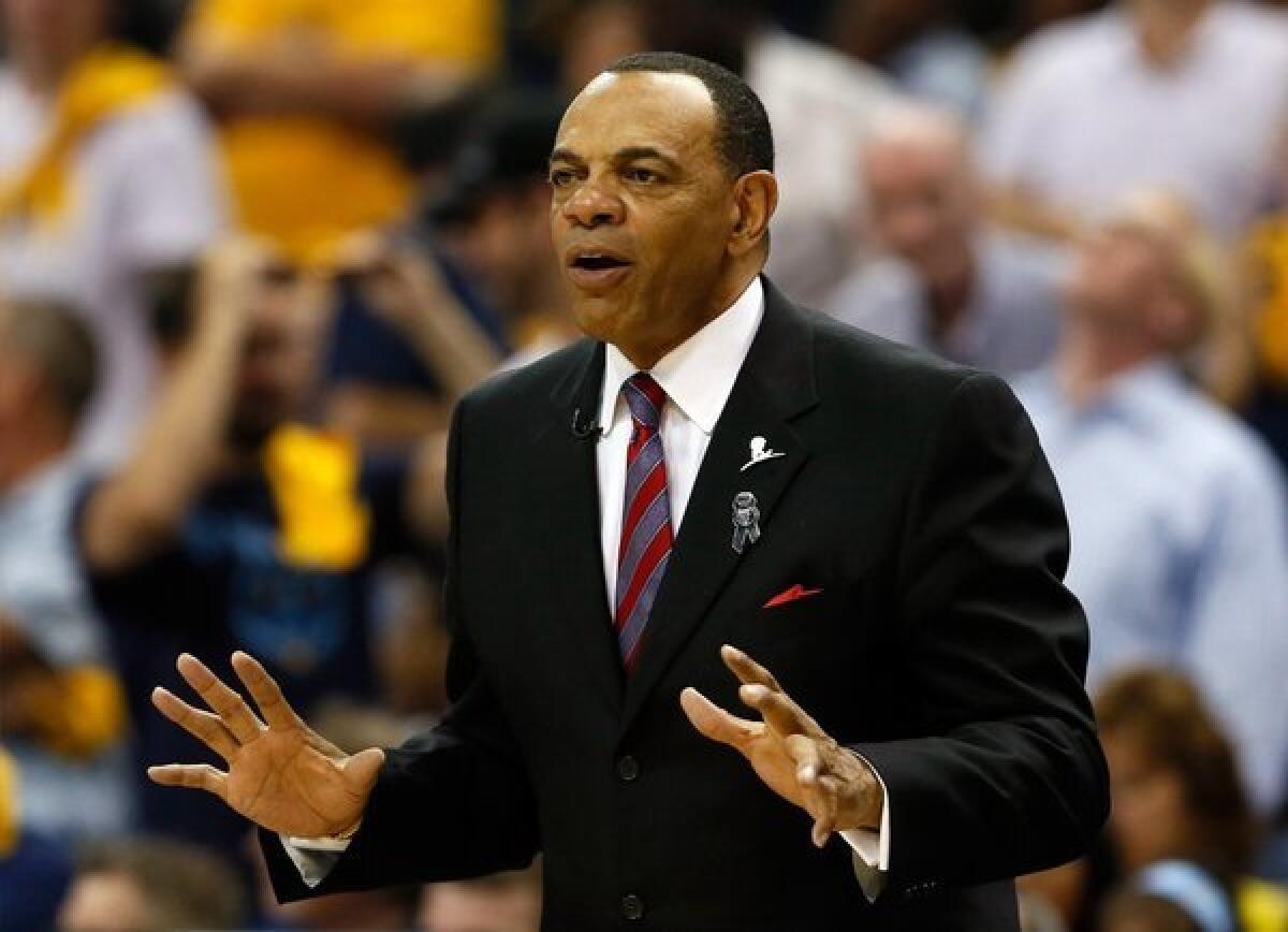 Lakers assistant coach Lionel Hollins instructs players on the court.