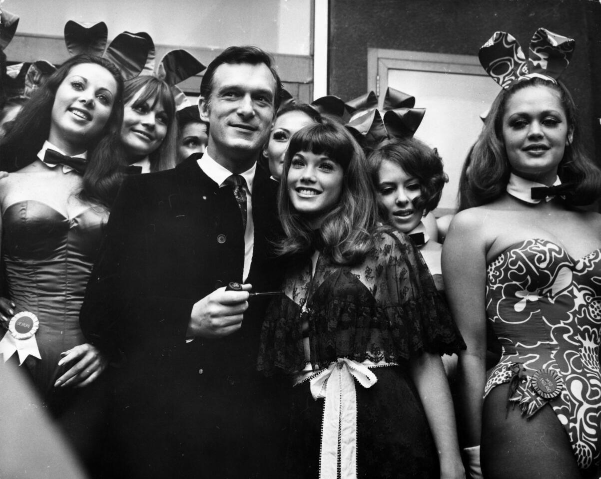 Hefner with actress Barbi Benton and others at his Playboy Club in London in 1969.